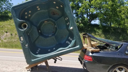 Porsche driver ticketed for towing hot tub with rickety wood rig