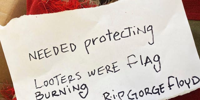 This photo provided by KRNV journalist Kenzie Margiott shows a note addressed to Margiott and a flag from a World War II battleship after it was anonymously returned to KRNV with the note in Reno, Nev., Tuesday, June 2, 2020. (Kenzie Margiott via AP)