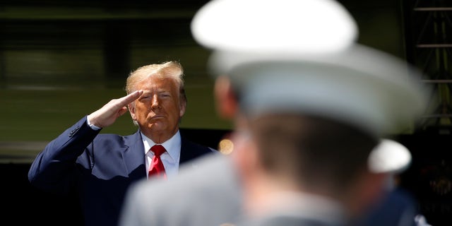 President Trump salutes after speaking to over 1,110 cadets in the Class of 2020 at a commencement ceremony on the parade field, at the United States Military Academy in West Point, N.Y., Saturday, June 13, 2020. (AP Photo/Alex Brandon)