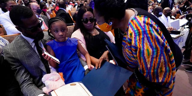 U.S. Rep. Sheila Jackson Lee, D-Texas, speaks with Roxie Washington and Gianna Floyd, the daughter of George Floyd during the funeral service for George Floyd at the Fountain of Praise church June 9, in Houston. (AP Photo/David J. Phillip, Pool)