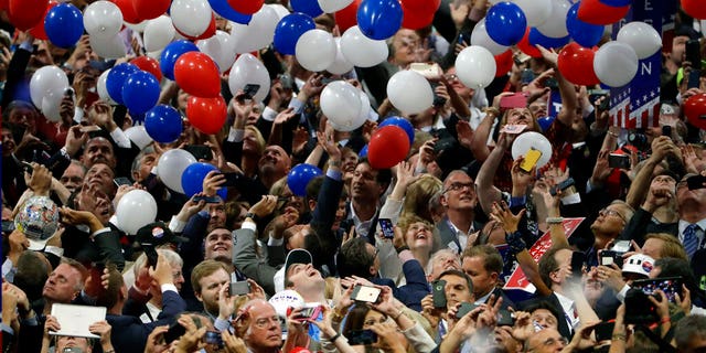 In this July 21, 2016, file photo, confetti and balloons fall during celebrations after then-Republican presidential candidate Donald Trump's acceptance speech on the final day of the Republican National Convention in Cleveland, Ohio.