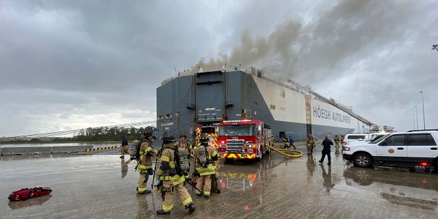 This photo provided by The Jacksonville Fire and Rescue Department shows firefighters responding to a fire after an explosion aboard a ship, June 4, in Jacksonville, Fla. (The Jacksonville Fire and Rescue Department via AP)