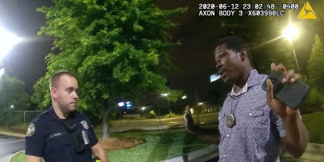 This screengrab taken from body camera video provided by the Atlanta Police Department shows Rayshard Brooks speaking with Officer Garrett Rolfe in the parking lot of a Wendy's restaurant, late Friday, June 12, 2020, in Atlanta.(Atlanta Police Department via AP)