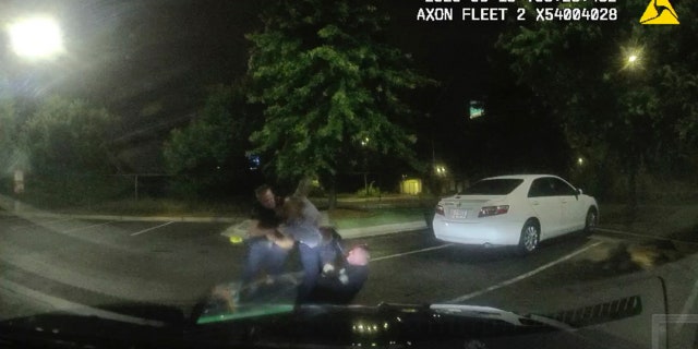 This screen grab taken from dashboard camera video provided by the Atlanta Police Department shows Rayshard Brooks, center, struggling with Officers Garrett Rolfe, left, and Devin Brosnan in the parking lot of a Wendy's restaurant, early Saturday, June 13, 2020, in Atlanta. (Atlanta Police Department via AP)