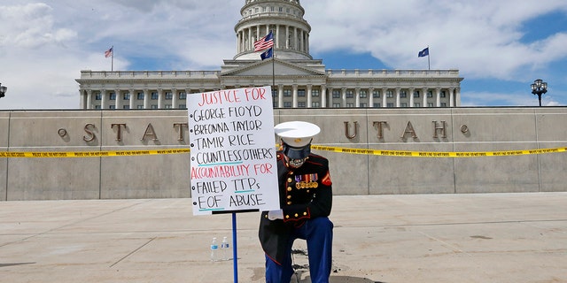 Todd Winn protesting in front of the Utah State Capitol on Friday. (AP Photo/Rick Bowmer)