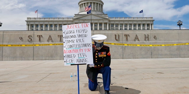 Todd Winn protesting in front of the Utah State Capitol on Friday. (AP Photo/Rick Bowmer)