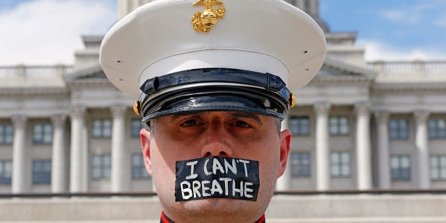 Marine vet Todd Winn, wearing a mask that read "I Can't Breathe," participating in a protest in front of the Utah State Capitol in Salt Lake City on Friday, amid protests around the world in the wake of the death of George Floyd. (AP Photo/Rick Bowmer)