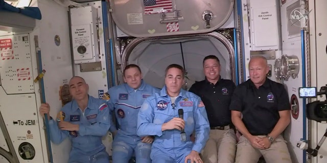 This photo provided by NASA shows Bob Behnken and Doug Hurley, far right, joining the crew at the International Space Station, after the SpaceX Dragon capsule pulled up to the station and docked Sunday, May 31, 2020. The Dragon capsule arrived Sunday morning, hours after a historic liftoff from Florida. It's the first time that a privately built and owned spacecraft has delivered a crew to the orbiting lab. (NASA via AP)