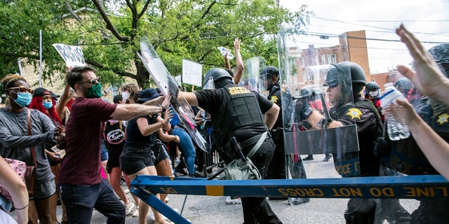 Protesters and police clash in Columbia, S.C., on Sunday. People protested against police brutality sparked by the death of George Floyd at the hands of police in Minneapolis on May 25. (Jason Lee/The Sun News via AP)