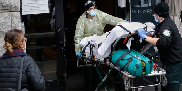 A patient is taken to Cobble Hill Health Center by emergency medical workers in the Brooklyn borough of New York on April 17, 2020. (AP Photo / John Minchillo, File)