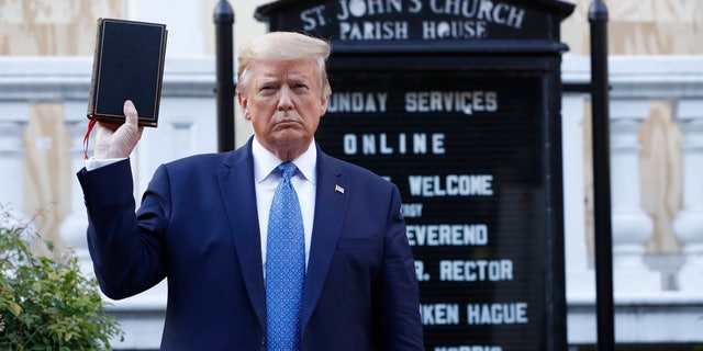 President Donald Trump holds a Bible as he visits outside St. John's Church across Lafayette Park from the White House Monday, June 1, 2020, in Washington. Park of the church was set on fire during protests on Sunday night. (AP Photo/Patrick Semansky)