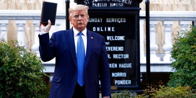 President Donald Trump holds a Bible as he visits outside St. John's Church across Lafayette Park from the White House Monday, June 1, 2020, in Washington. Part of the church was set on fire during protests on Sunday night.