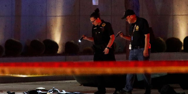 Investigators look at the scene of an officer involved shooting in front of a federal courthouse after a Black Lives Matter protest Tuesday, June 2, 2020, in Las Vegas. Protests continue over the death of George Floyd, who died after being restrained by Minneapolis police officers on May 25. (Associated Press)