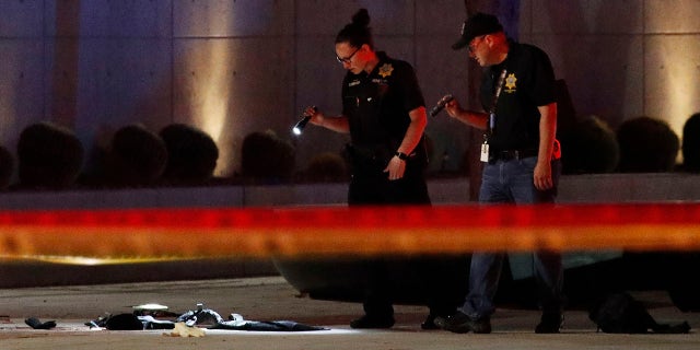 Investigators look at the scene of an officer involved shooting in front of a federal courthouse after a Black Lives Matter protest Tuesday, June 2, 2020, in Las Vegas. Protests continue over the death of George Floyd, who died after being restrained by Minneapolis police officers on May 25. (Associated Press)