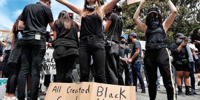 A protester cries during a Black Lives Matter protest in downtown Los Angeles on Tuesday, June 2, 2020, over the death of George Floyd, a black man who was in police custody in Minneapolis.