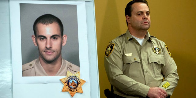 Las Vegas Police Assistant Sheriff Chris Jones stands by a photo of Metro Police officer Shay K. Mikalonis, 29, a four-year veteran of the department, during a media briefing at police headquarters in Las Vegas on Tuesday, June 2, 2020. Mikalonis was shot Monday night in Las Vegas. (Associated Press)