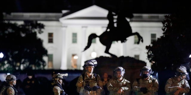 A line of DC National Guard members stand in Lafayette Park as demonstrators gather to protest the death of George Floyd near the White House in Washington. (AP Photo/Alex Brandon)