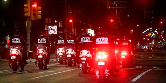 Police ride their scooters through the East Village neighborhood of New York, patrolling the streets during an imposed curfew on Tuesday, June 2, 2020, in New York. Thousands of demonstrators protesting the death of George Floyd remained on New York City streets on Tuesday after an 8 p.m. curfew put in place by officials struggling to stanch destruction and growing complaints that the nation's biggest city was reeling out of control night after night.