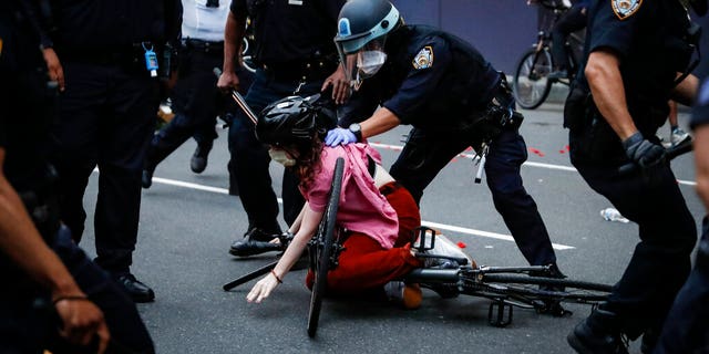 A protester is arrested by NYPD officers for violating curfew beside the iconic Plaza Hotel on 59th Street, Wednesday, June 3, 2020, in the Manhattan borough of New York. Protests continued following the death of George Floyd, who died after being restrained by Minneapolis police officers on Memorial Day. 