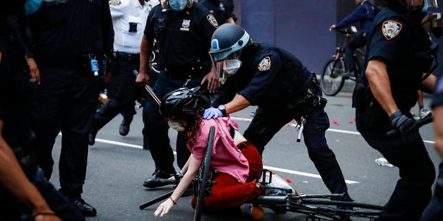 A protester is arrested by NYPD officers for violating curfew beside the iconic Plaza Hotel on 59th Street, Wednesday, June 3, 2020, in the Manhattan borough of New York. Protests continued following the death of George Floyd, who died after being restrained by Minneapolis police officers on Memorial Day.