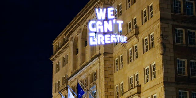Demonstrators project the words 'we can't breathe' onto the front of the Hay Adams hotel as protests continue over the death of George Floyd, Wednesday, June 3, 2020, near the White House in Washington, D.C.