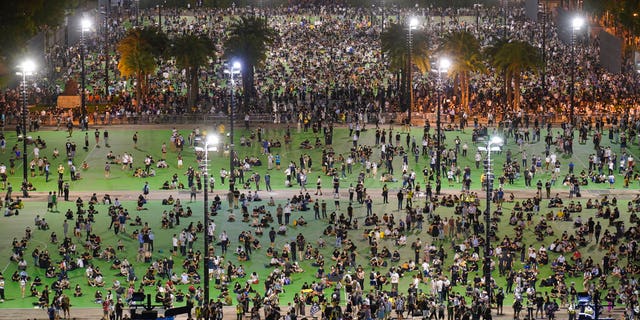 In this aerial view, participants gather for a vigil to remember the victims of the 1989 Tiananmen Square Massacre, despite permission for it being officially denied, at Victoria Park in Causeway Bay, Hong Kong, Thursday, June 4, 2020. (AP Photo/Vincent Yu)