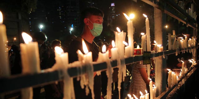 Participants light candles during a vigil for the victims of the 1989 Tiananmen Square Massacre at Victoria Park in Causeway Bay, Hong Kong, Thursday, June 4, 2020, despite applications for it being officially denied. (AP Photo/Kin Cheung)