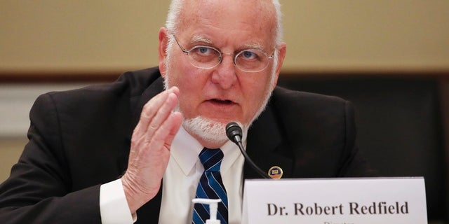 Dr Robert Redfield, director of the Centers for Disease Control and Prevention, signed a memo supporting an expert group's recommendations for vaccine distribution.  (Tasos Katopodis / Pool via AP)