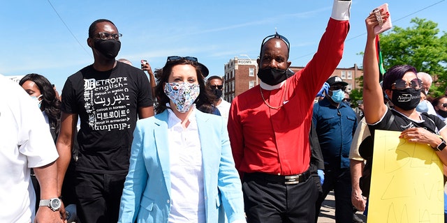 Michigan Gov. Gretchen Whitmer, center, marches with others, on Woodward during a rally in Highland Park, Thursday, June 4, 2020. (Clarence Tabb, Jr./Detroit News via AP)