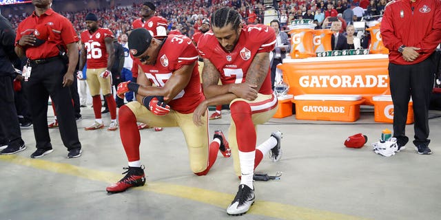 FILE - In this Sept. 12, 2016, file photo, San Francisco 49ers safety Eric Reid (35) and quarterback Colin Kaepernick (7) kneel during the national anthem before an NFL football game against the Los Angeles Rams in Santa Clara, Calif. (AP Photo/Marcio Jose Sanchez, File)