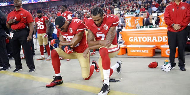 FILE - In this Sept. 12, 2016, file photo, San Francisco 49ers safety Eric Reid (35) and quarterback Colin Kaepernick (7) kneel during the national anthem before an NFL football game against the Los Angeles Rams in Santa Clara, Calif. (AP Photo/Marcio Jose Sanchez, File)