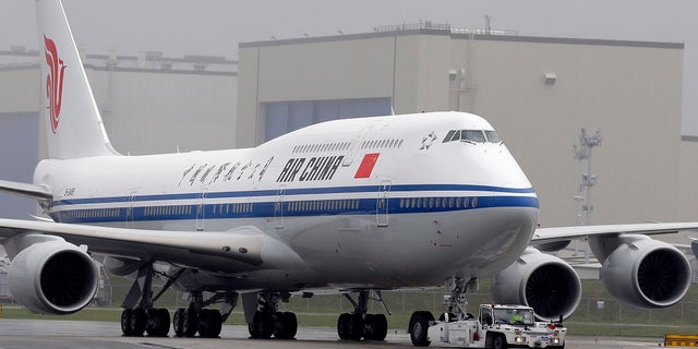 Many airlines are suspending flights in and out of Beijing over a possible second wave of COVID-19 cases. (AP Photo/Ted S. Warren, File)