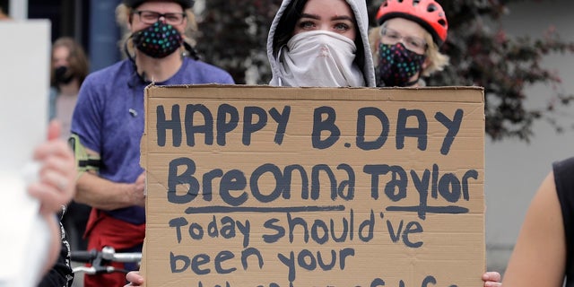 A person holds a sign last week that mentions Breonna Taylor, a black woman killed by Kentucky police on March 13, during a protest in Tacoma, Wash., against police brutality. Taylor would have turned 27-years-old on June 5. (AP Photo/Ted S. Warren)