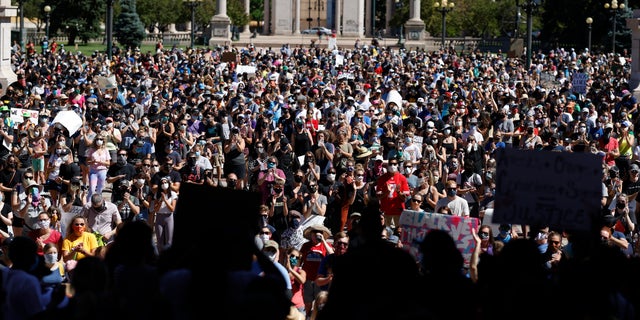 Demonstrators crowd into Civic Center Park during a rally calling for more oversight of the police Sunday, June 7, 2020, in Denver. Demonstrators marched from the park, which is in the heart of downtown, east along Colfax Avenue to City Park after the rally. (AP Photo/David Zalubowski)