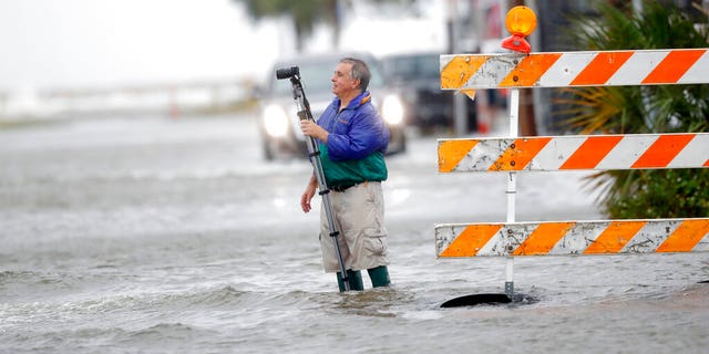 Charles Marsala recording a rising storm surge from Lake Pontchartrain in advance of Tropical Storm Cristobal on Sunday.