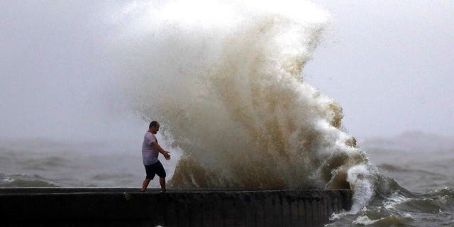 A wave crashing near Orleans Harbor at Lake Pontchartrain in New Orleans on Sunday.
