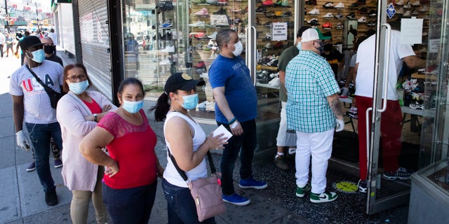 Shoppers wear masks outside a Sneaker Box store in the Bronx borough of New York City, June 8, 2020. (Associated Press)