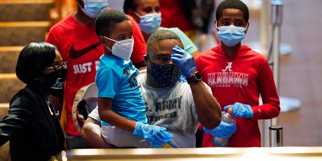 Mourners passing by the casket of George Floyd during a public visitation for Floyd at the Fountain of Praise church in Houston.