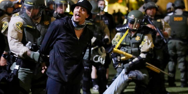 Demonstrators being arrested for curfew violations in downtown Los Angeles during a protest over the death of George Floyd.