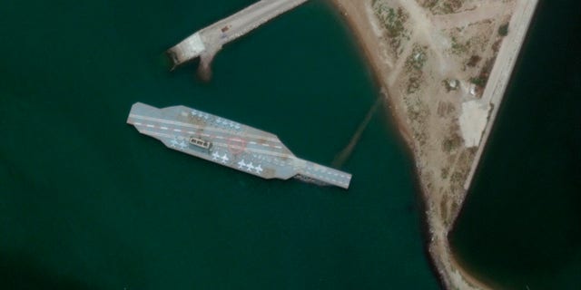 In this Sunday, June 7, 2020 satellite photo a fake aircraft carrier is seen off the coast of Bandar Abbas, Iran.