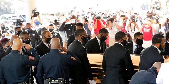 Texas Southern University police saluting as family and guests arrived for George Floyd's funeral service. (AP Photo/Eric Gay)