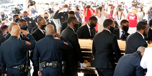 Texas Southern University police saluting as family and guests arrived for George Floyd's funeral service. (AP Photo/Eric Gay)