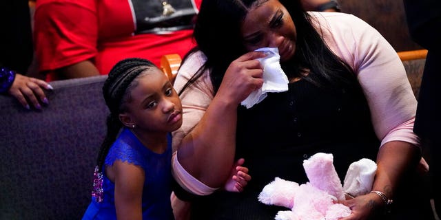 Roxie Washington weeps with Gianna Floyd, the daughter of George Floyd as they attend the funeral service for George Floyd at The Fountain of Praise church Tuesday, June 9, 2020, in Houston. (AP Photo/David J. Phillip, Pool)