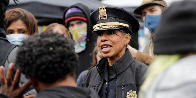 Seattle Police Chief Carmen Best talks with activists near a plywood-covered and closed Seattle police precinct Tuesday, June 9, 2020, in Seattle, following protests over the death of George Floyd, a black man who was in police custody in Minneapolis. (AP Photo/Elaine Thompson)