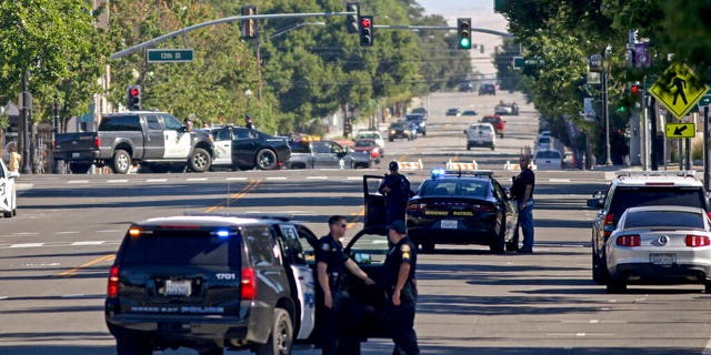 Law enforcement personnel from several jurisdictions patrolling downtown Paso Robles, Calif., on Wednesday.