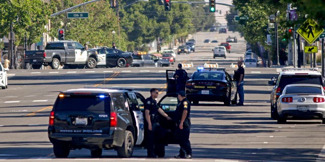 Law enforcement personnel from several jurisdictions patrolling downtown Paso Robles, Calif., on Wednesday.