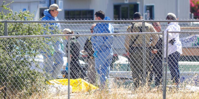 Members of San Luis Obispo County Sheriff-Coronor's office and Paso Robles Police department investigate the scene of a shooting, Wednesday June 10, 2020 in Paso Robles, Calif.