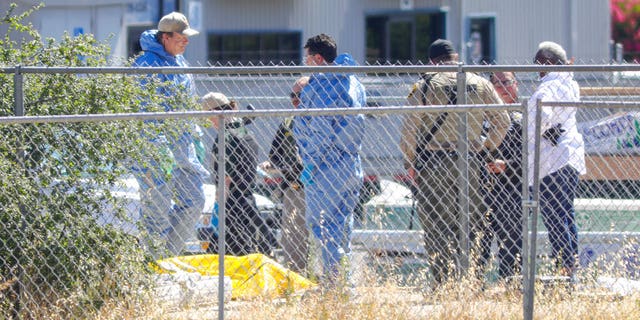 Members of San Luis Obispo County Sheriff-Coronor's office and Paso Robles Police department investigate the scene of a shooting, Wednesday June 10, 2020 in Paso Robles, Calif. 