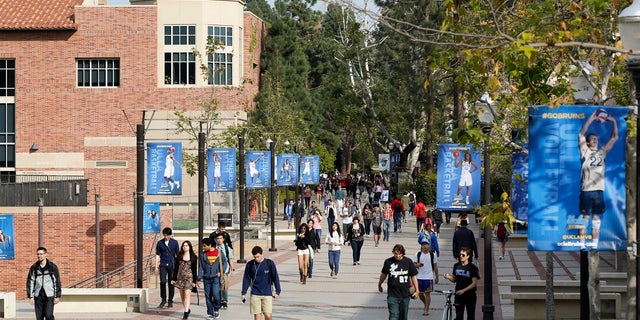 Students walk on the University of California, Los Angeles campus. The University of California Board of Regents voted Monday to support a statewide measure to repeal a ban on race and gender-based considerations in college admissions. (AP Photo/Damian Dovarganes, File)