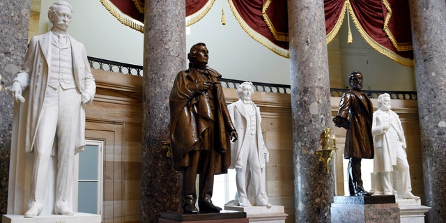 FILE - In this June 24, 2015 file photo, a statue of Jefferson Davis, second from left, president of the Confederate States from 1861 to 1865, is on display in Statuary Hall on Capitol Hill in Washington. The House voted July 22, 2020, to remove statues of Confederate figures such as Jefferson Davis from the U.S. Capitol. (AP Photo/Susan Walsh, File)